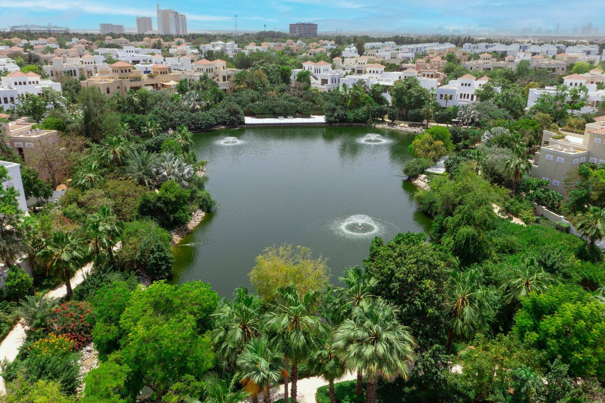 Aerial view over Al Barari's lakes and botanical planting